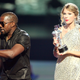 Kanye West (L) jumps onstage after Taylor Swift (C) won the “Best Female Video” award during the 2009 MTV Video Music Awards on September 13, 2009, in New York City.